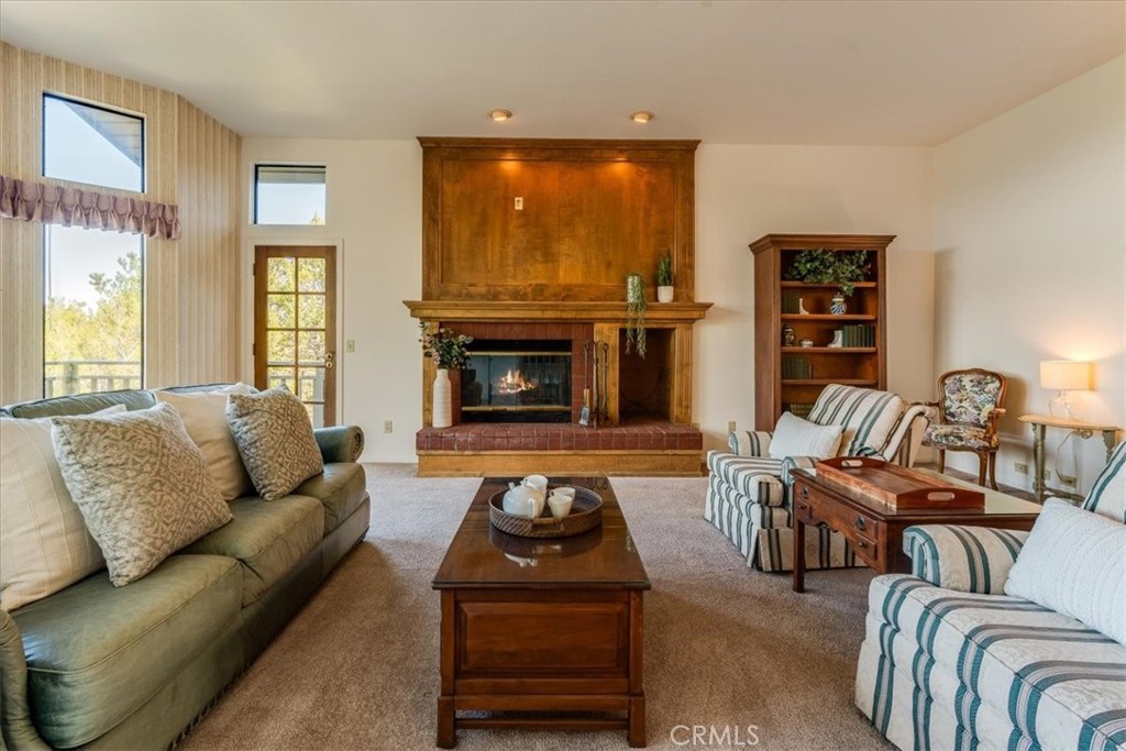 3171 Rogers Road Cambria, CA 93428 - Photo 10 of 73 a living room with furniture a flat screen tv and a fireplace