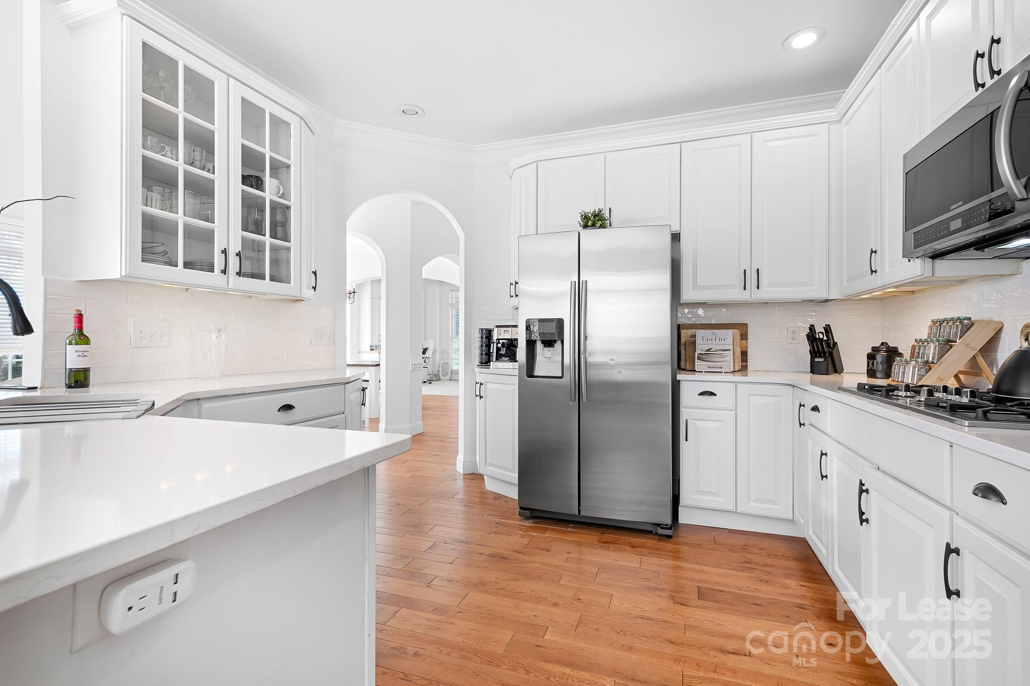 7277 Willowbrook Drive Denver, NC 28037 - Photo 13 of 33 a kitchen with stainless steel appliances a refrigerator sink and cabinets