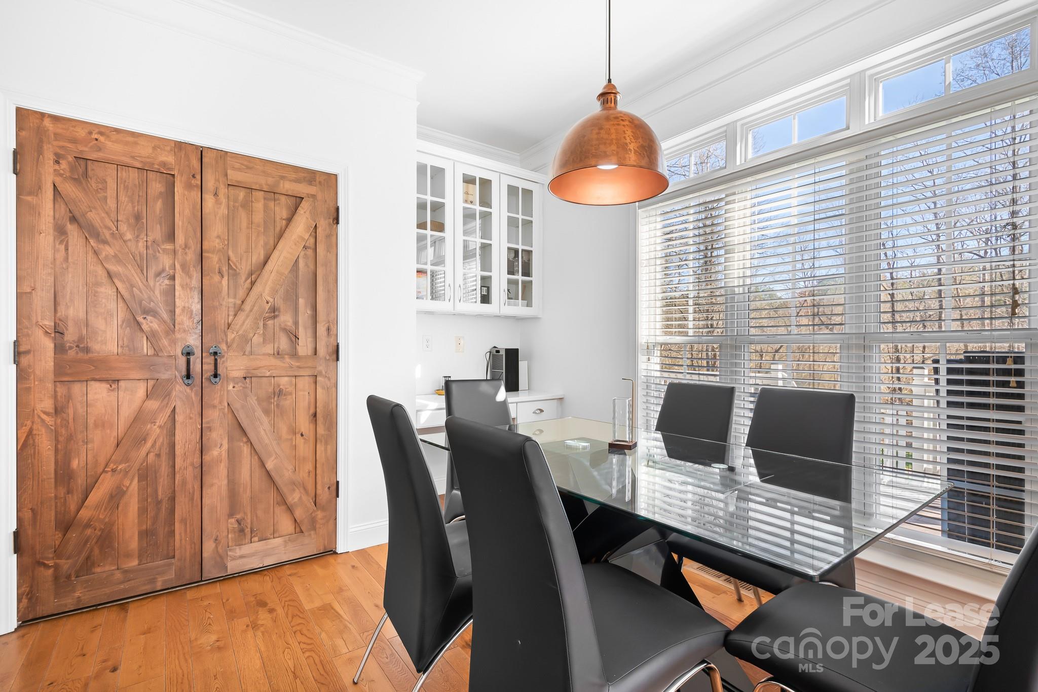 7277 Willowbrook Drive Denver, NC 28037 - Photo 15 of 33 a view of a dining room with furniture window and wooden floor