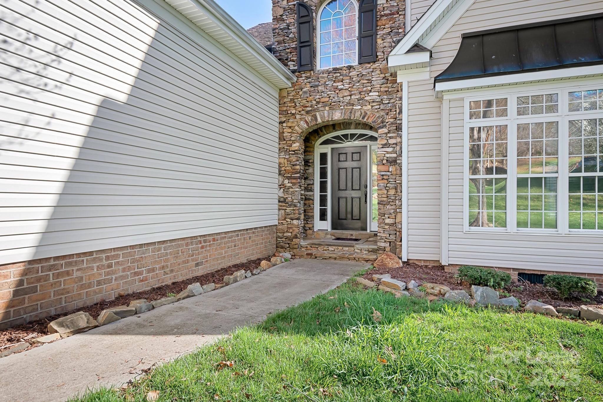7277 Willowbrook Drive Denver, NC 28037 - Photo 4 of 33 a front view of a house with a yard