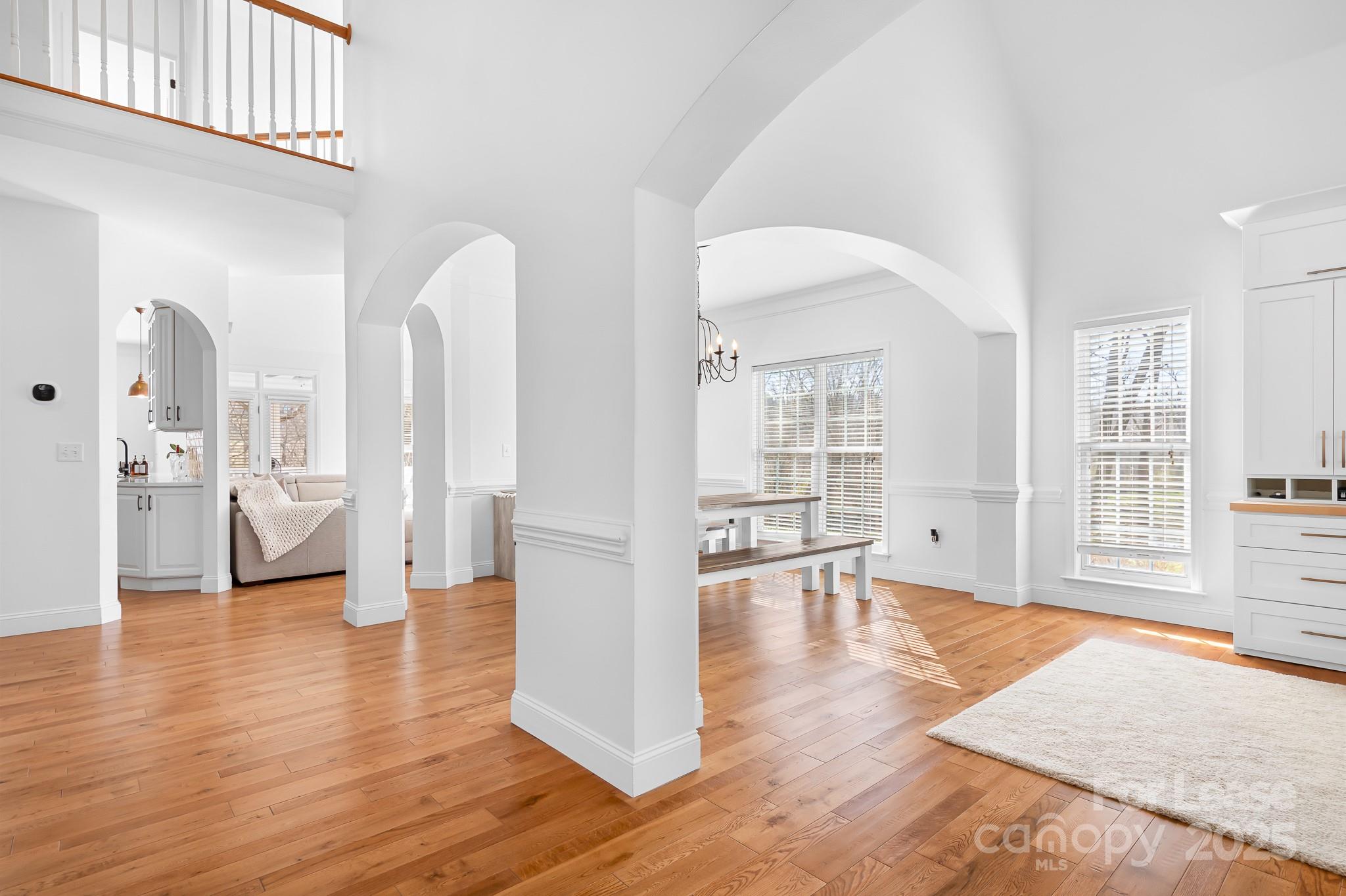 7277 Willowbrook Drive Denver, NC 28037 - Photo 6 of 33 an empty room with wooden floor and a large window