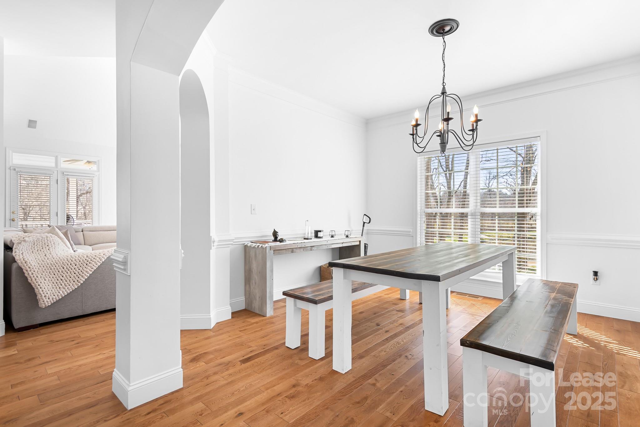 7277 Willowbrook Drive Denver, NC 28037 - Photo 8 of 33 a view of a room with kitchen island stainless steel appliances wooden floor and windows
