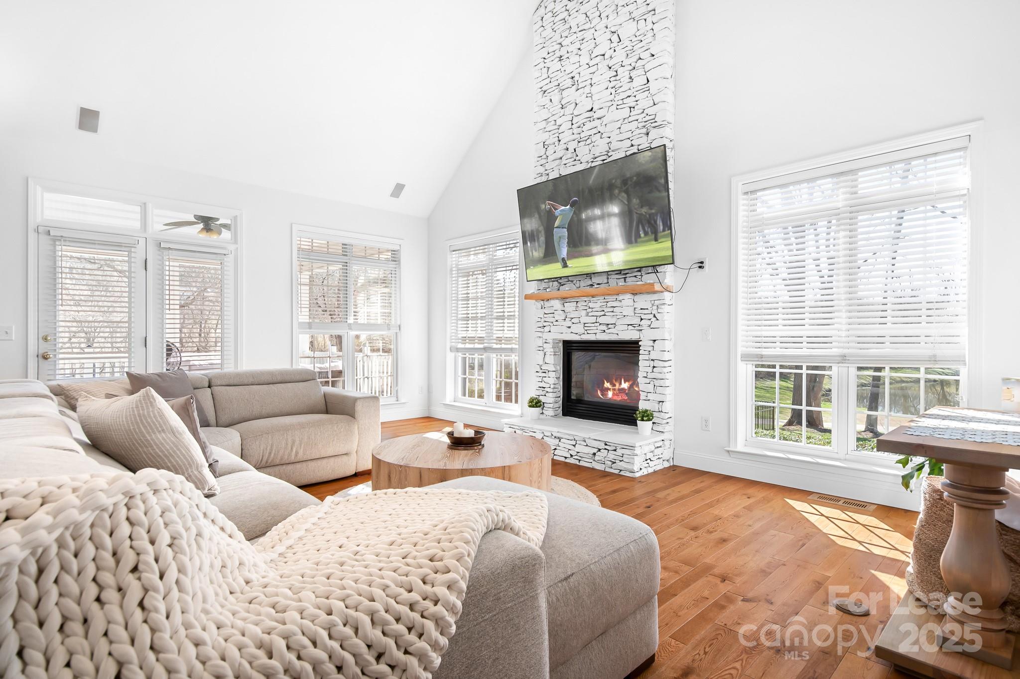 7277 Willowbrook Drive Denver, NC 28037 - Photo 9 of 33 a bedroom with a bed and a fireplace