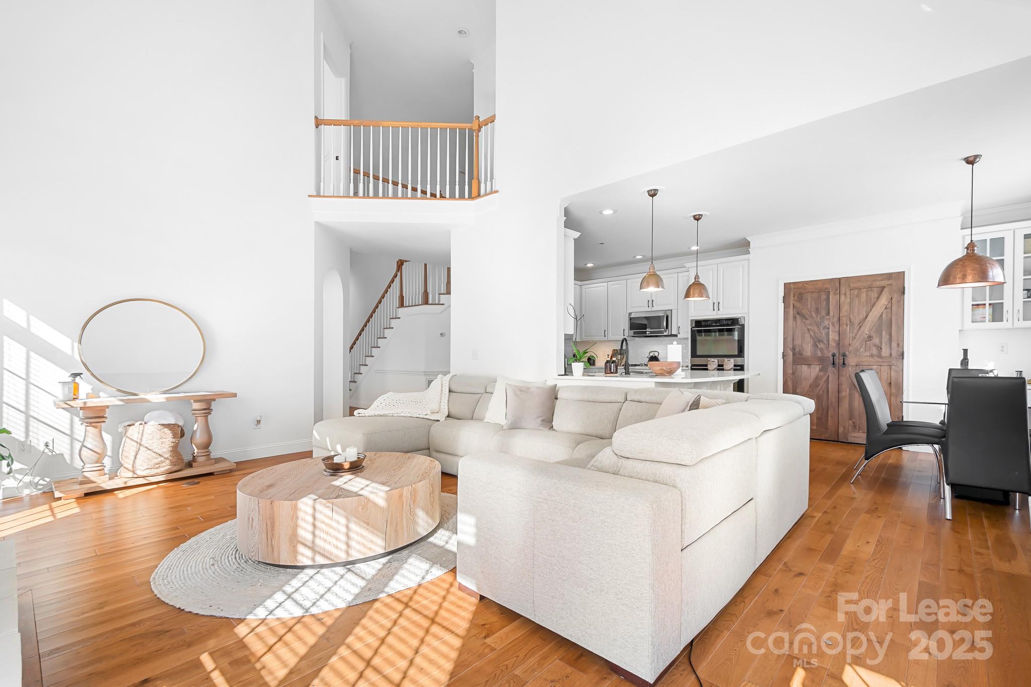 7277 Willowbrook Drive Denver, NC 28037 - Photo 10 of 33 a living room with furniture a fireplace and a dining table with wooden floor