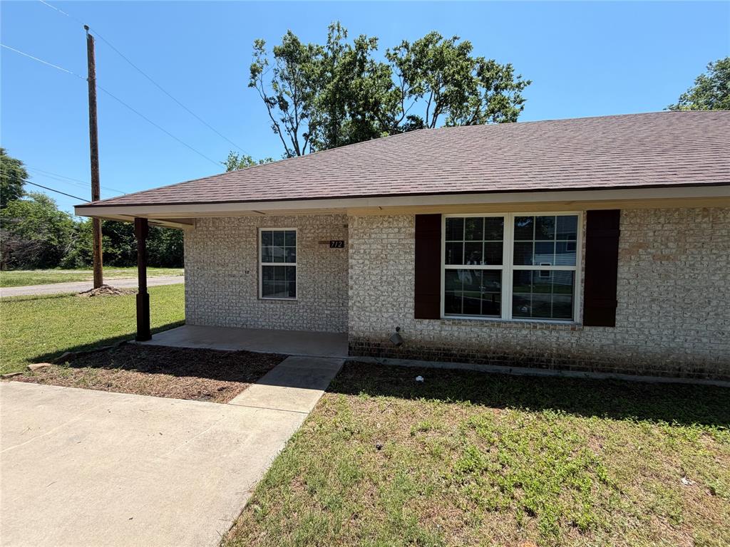 712 Seven Oaks Road, Unit 712 Bonham, TX 75418 - Photo 1 of 14 a front view of a house with a yard