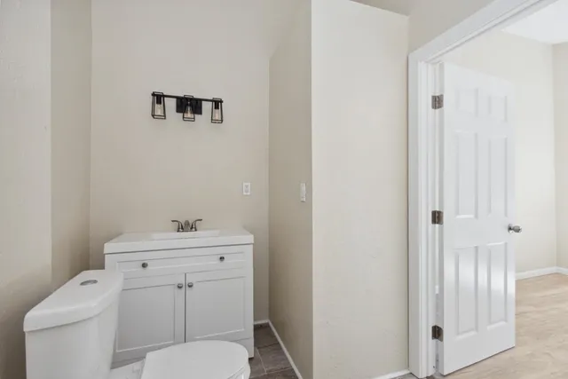 a view of a room with wooden floor and window