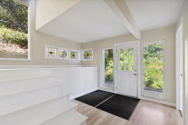 a view of a field with a tree in the background