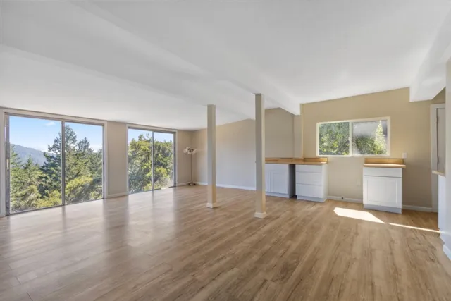 a view of a kitchen with wooden floor and a kitchen
