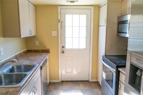 a kitchen with a sink stove and refrigerator