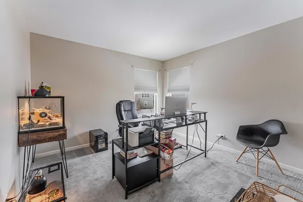 a work room with furniture and rug