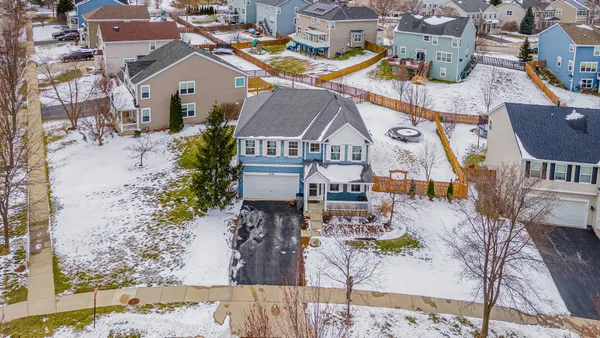 an aerial view of a house with a swimming pool