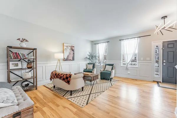 a living room with furniture and wooden floor