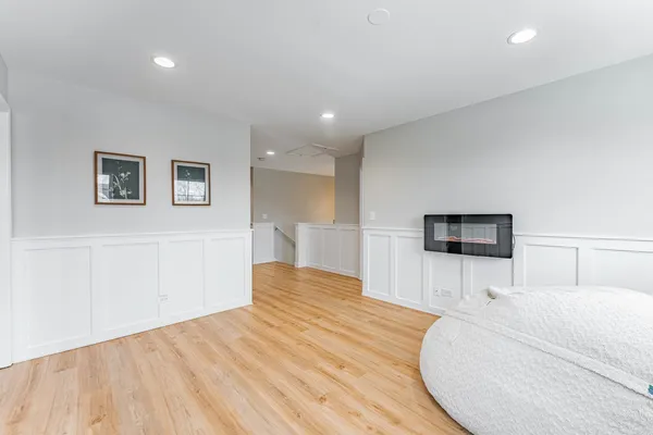 a bedroom with a bed and a night stand