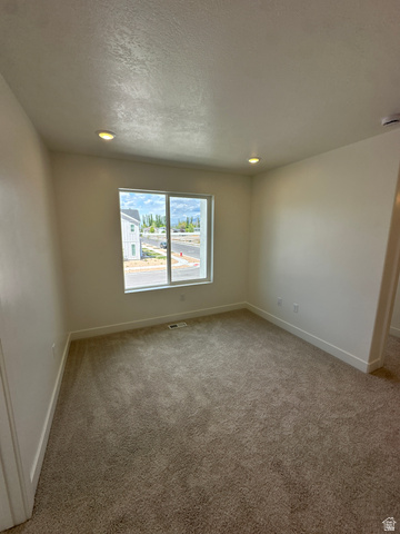 1225 West 500 South Logan, UT 84321 - Photo 26 of 39 Carpeted interior space featuring a large window, white baseboards, recessed lighting, and light-colored walls