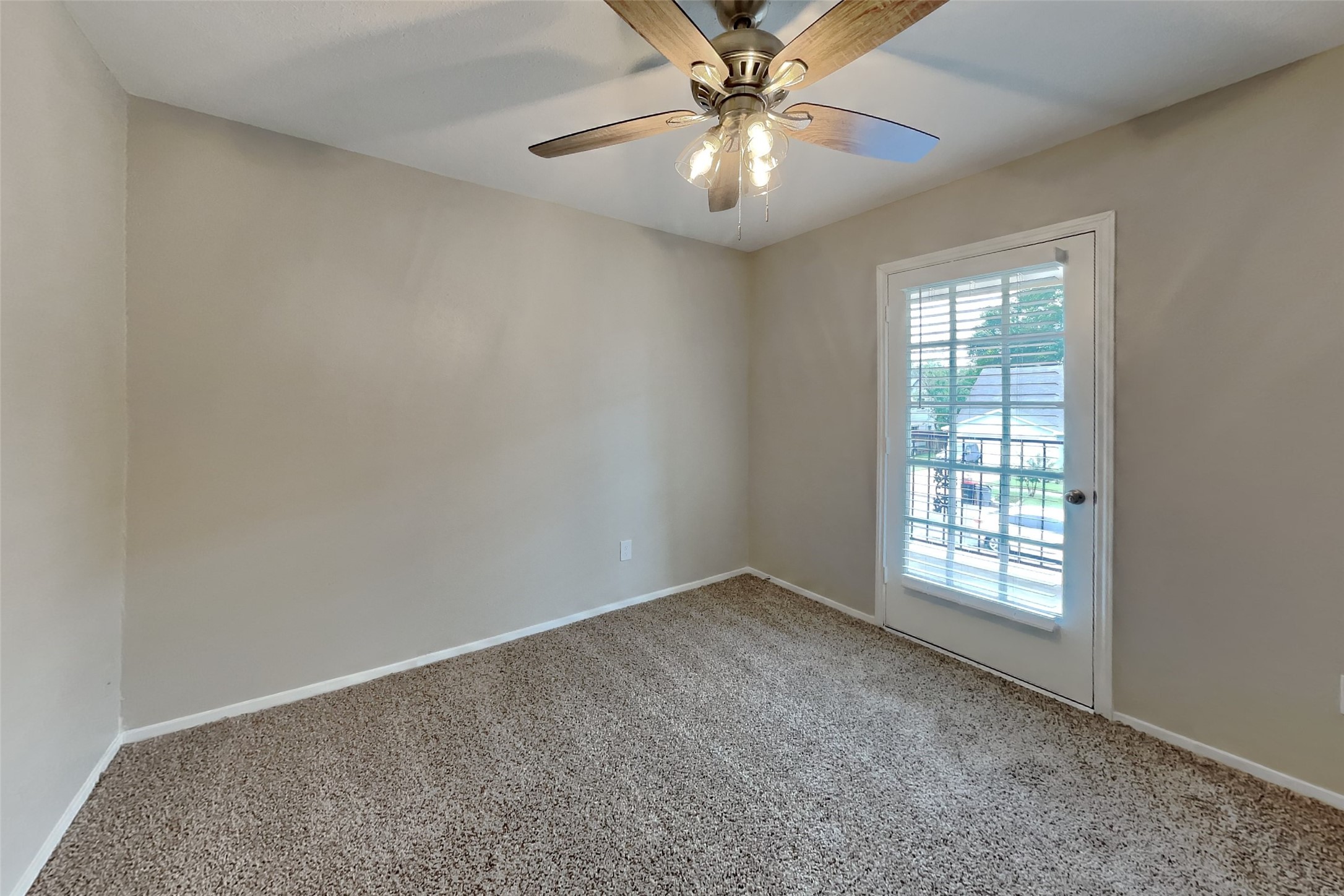 10015 Rippling Fields Drive Houston, TX 77064 - Photo 13 of 24 an empty room with windows and fan
