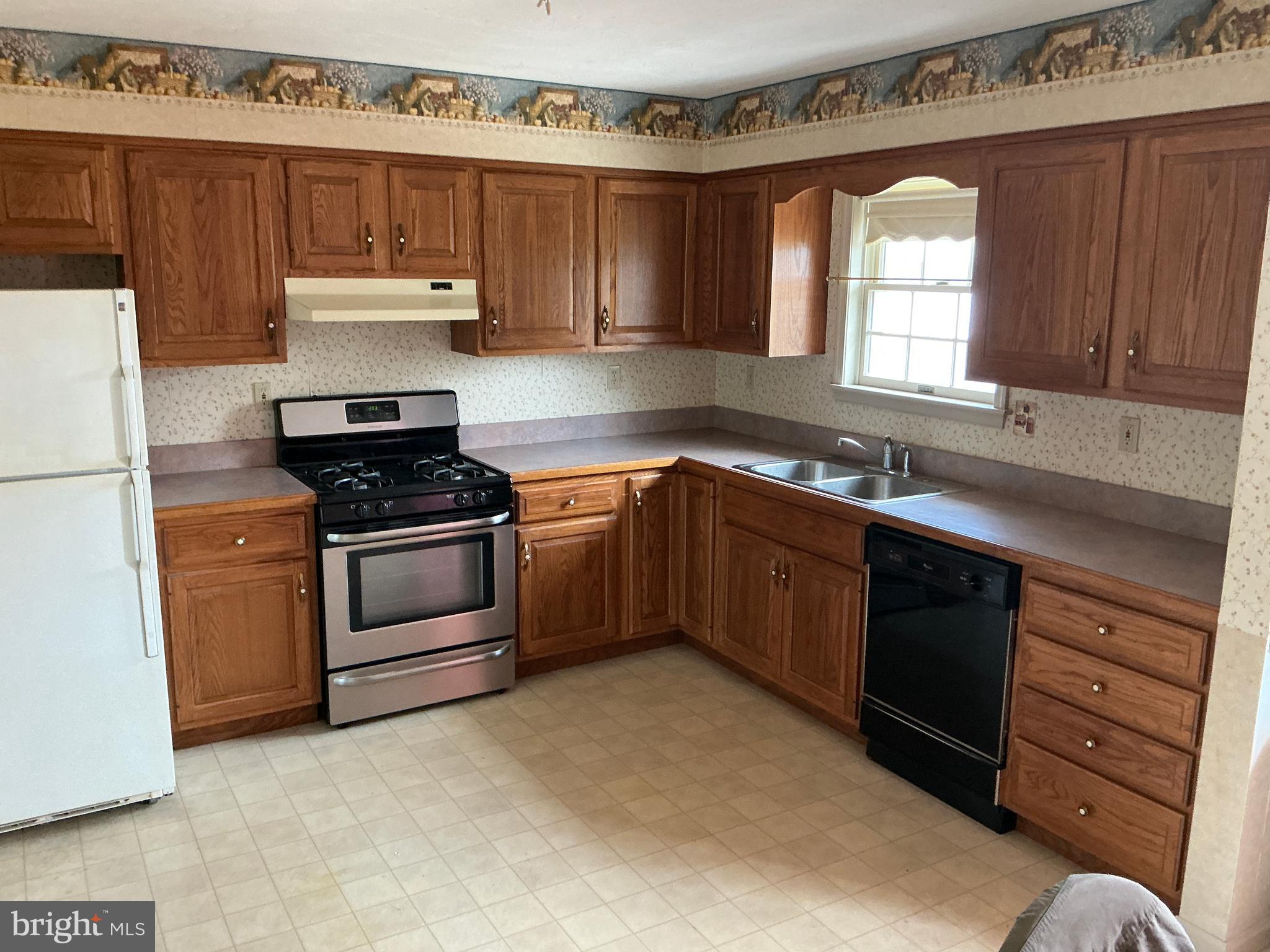 665 Game Lands Road Aspers, PA 17304 - Photo 11 of 40 a kitchen with a stove sink and cabinets