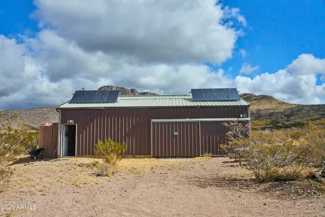a large kitchen with stainless steel appliances granite countertop a stove a sink dishwasher and cabinets with wooden floor