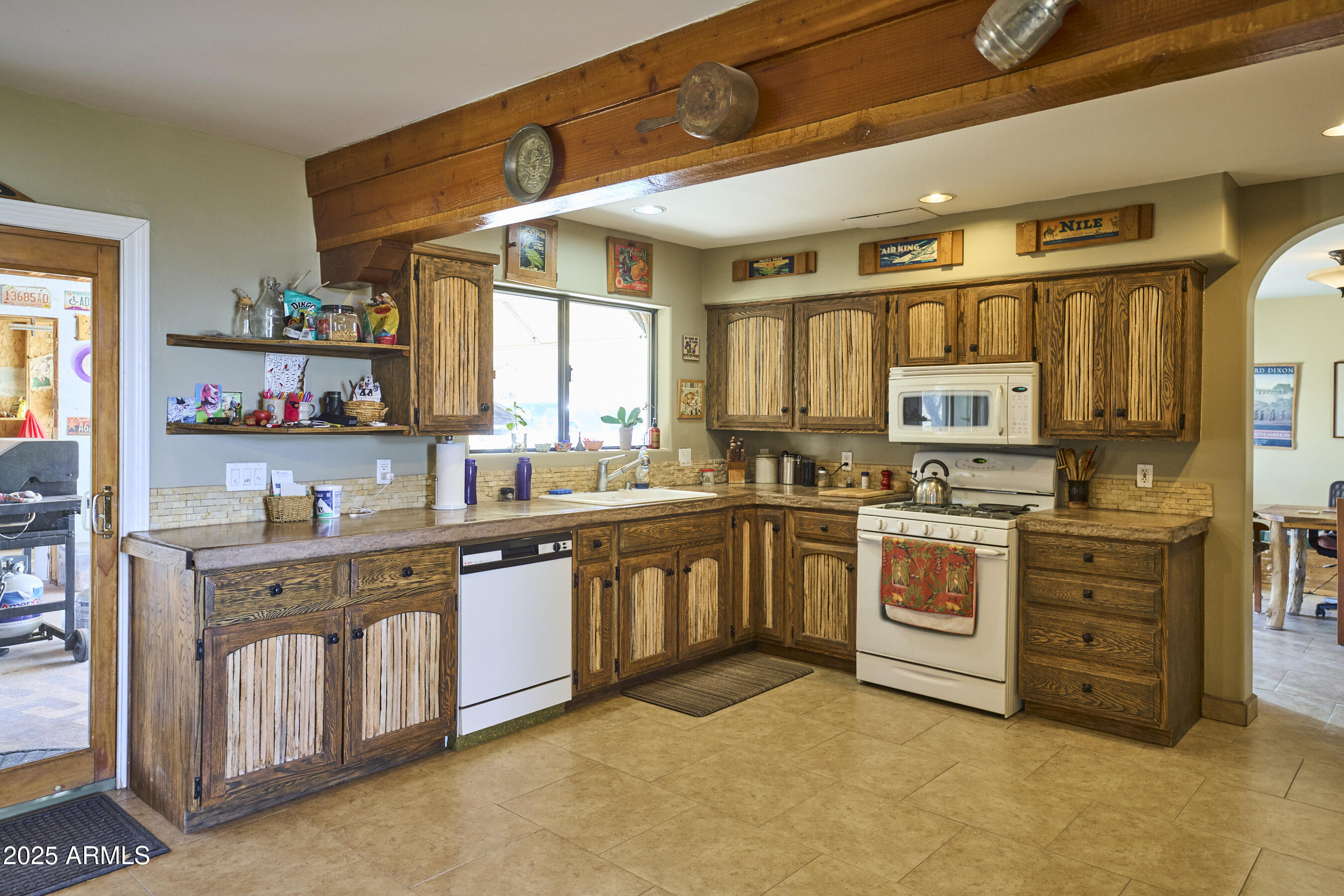 Undisclosed Address Bisbee, AZ 85603 - Photo 31 of 78 a large kitchen with stainless steel appliances granite countertop a stove a sink dishwasher and cabinets with wooden floor
