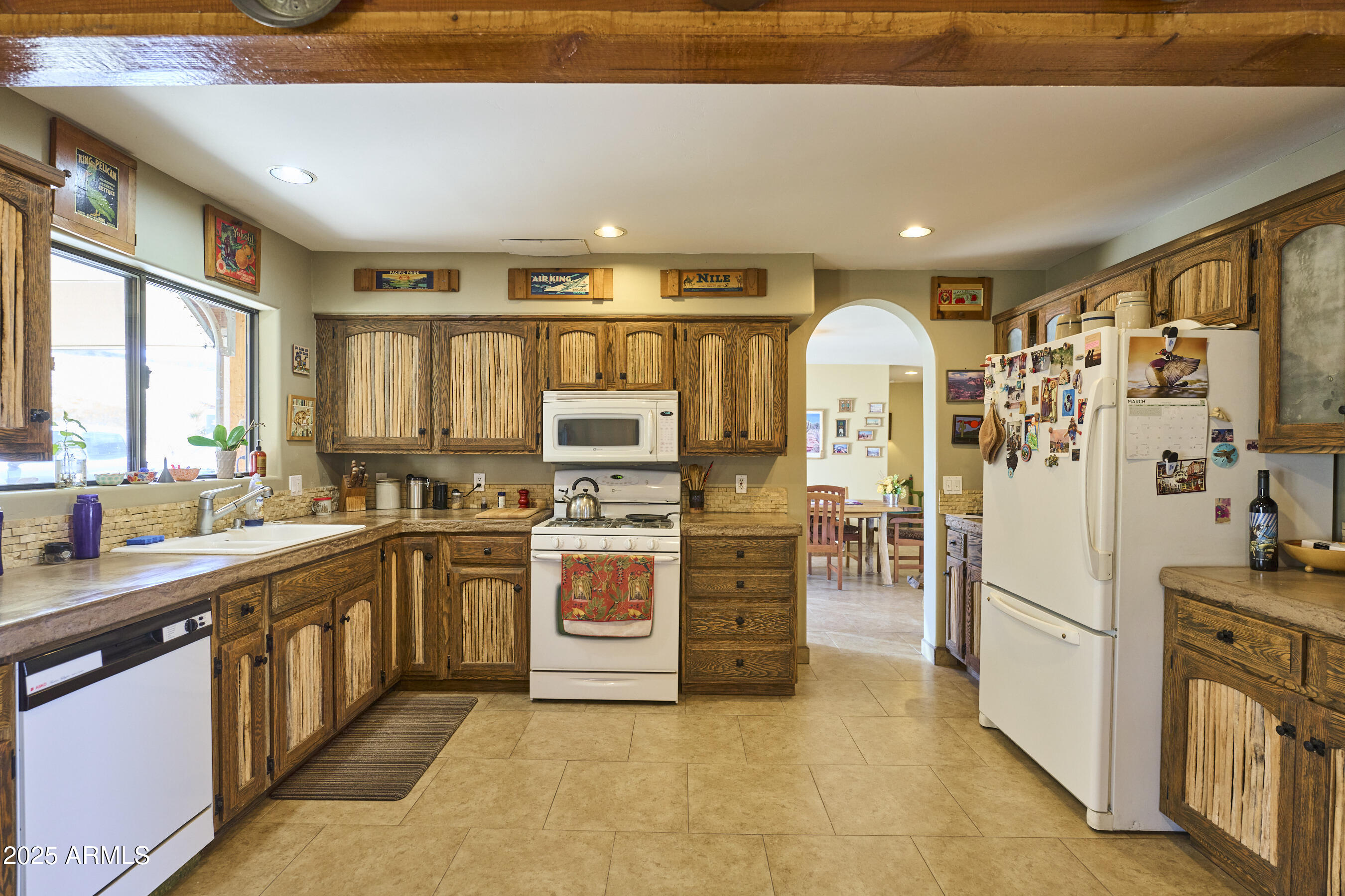 Undisclosed Address Bisbee, AZ 85603 - Photo 33 of 78 a kitchen with stainless steel appliances a refrigerator sink and cabinets