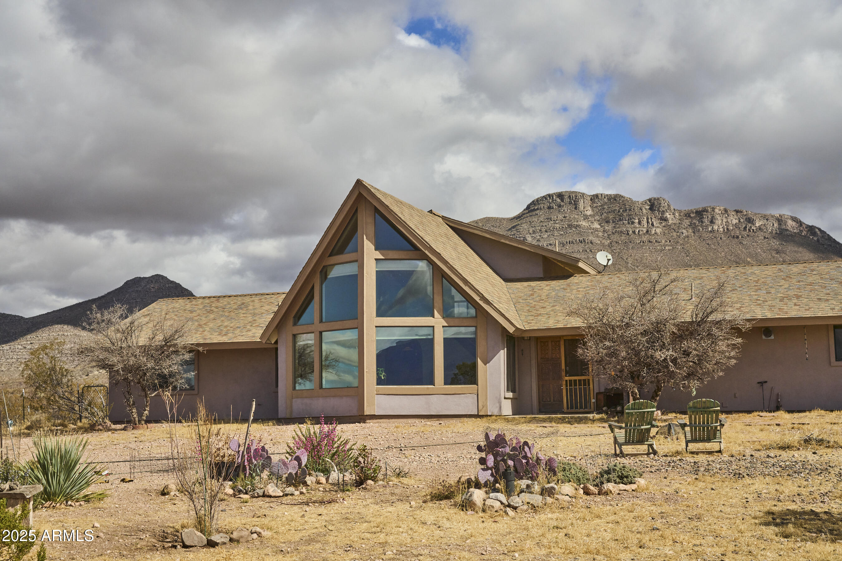 Undisclosed Address Bisbee, AZ 85603 - Photo 5 of 78 a front view of a house with a yard covered in snow