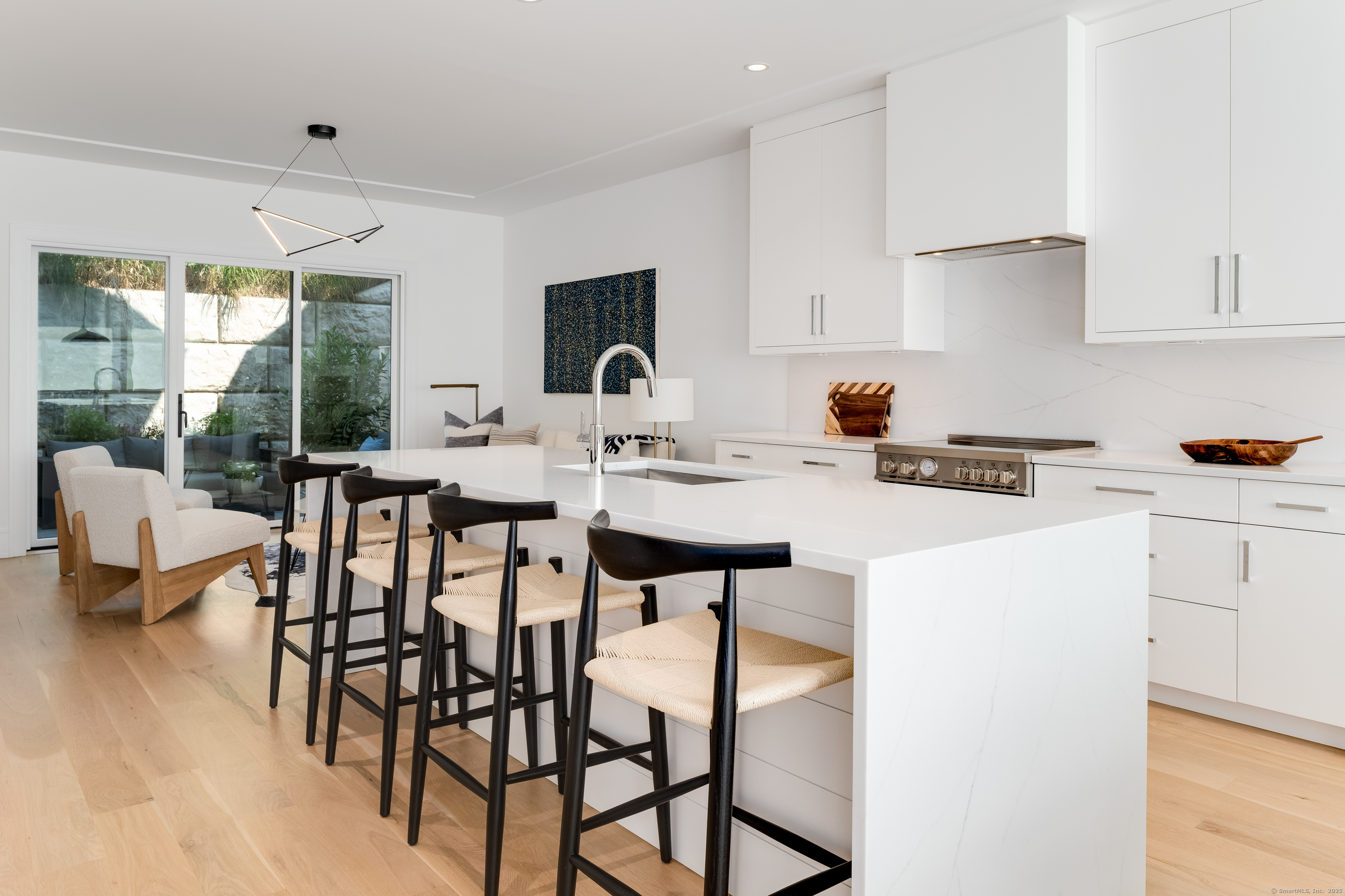 a kitchen with a dining table chairs and white cabinets