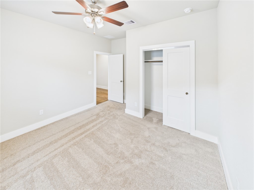 5306 Lyle Place Bryan, TX 77807 - Photo 12 of 18 an empty room with closet and a ceiling fan