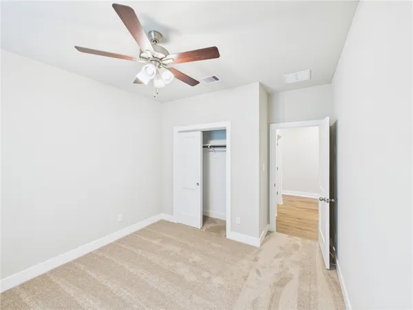 a view of a livingroom with a ceiling fan & a ceiling fan