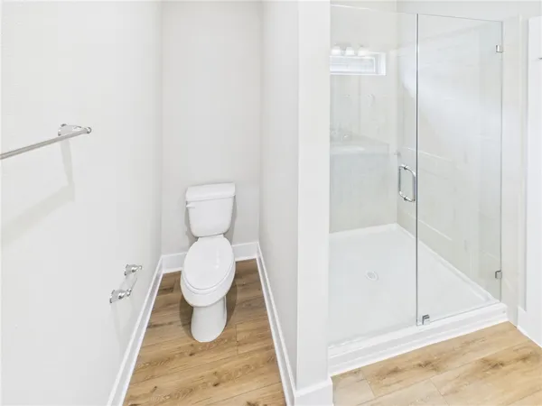 a bathroom with a toilet and a shower
