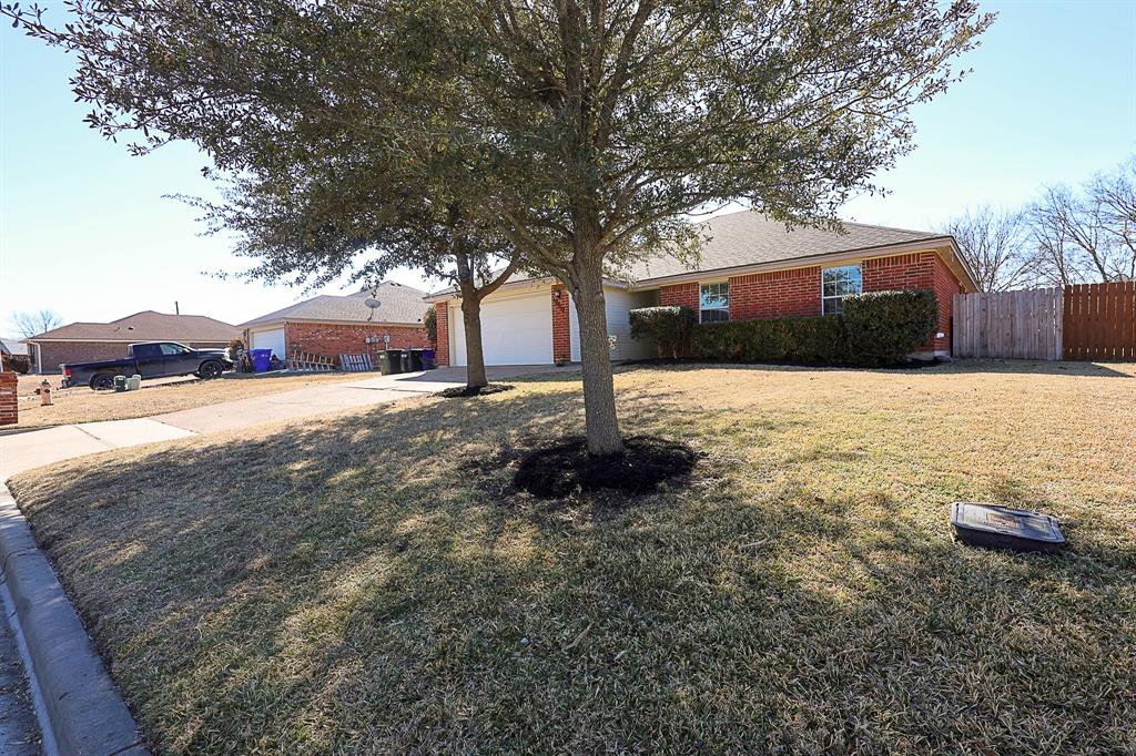 10812 Lilry Road Waco, TX 76708 - Photo 2 of 25 Ranch-style house featuring driveway, brick siding, and an attached garage