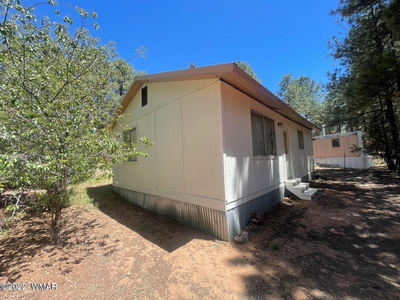 2891 Tracy Road Overgaard, AZ 85933 - Photo 2 of 9 a view of a house with a yard
