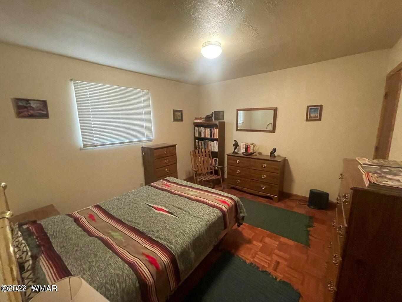 2891 Tracy Road Overgaard, AZ 85933 - Photo 9 of 9 a bedroom with a bed and a flat tv screen on the dresser
