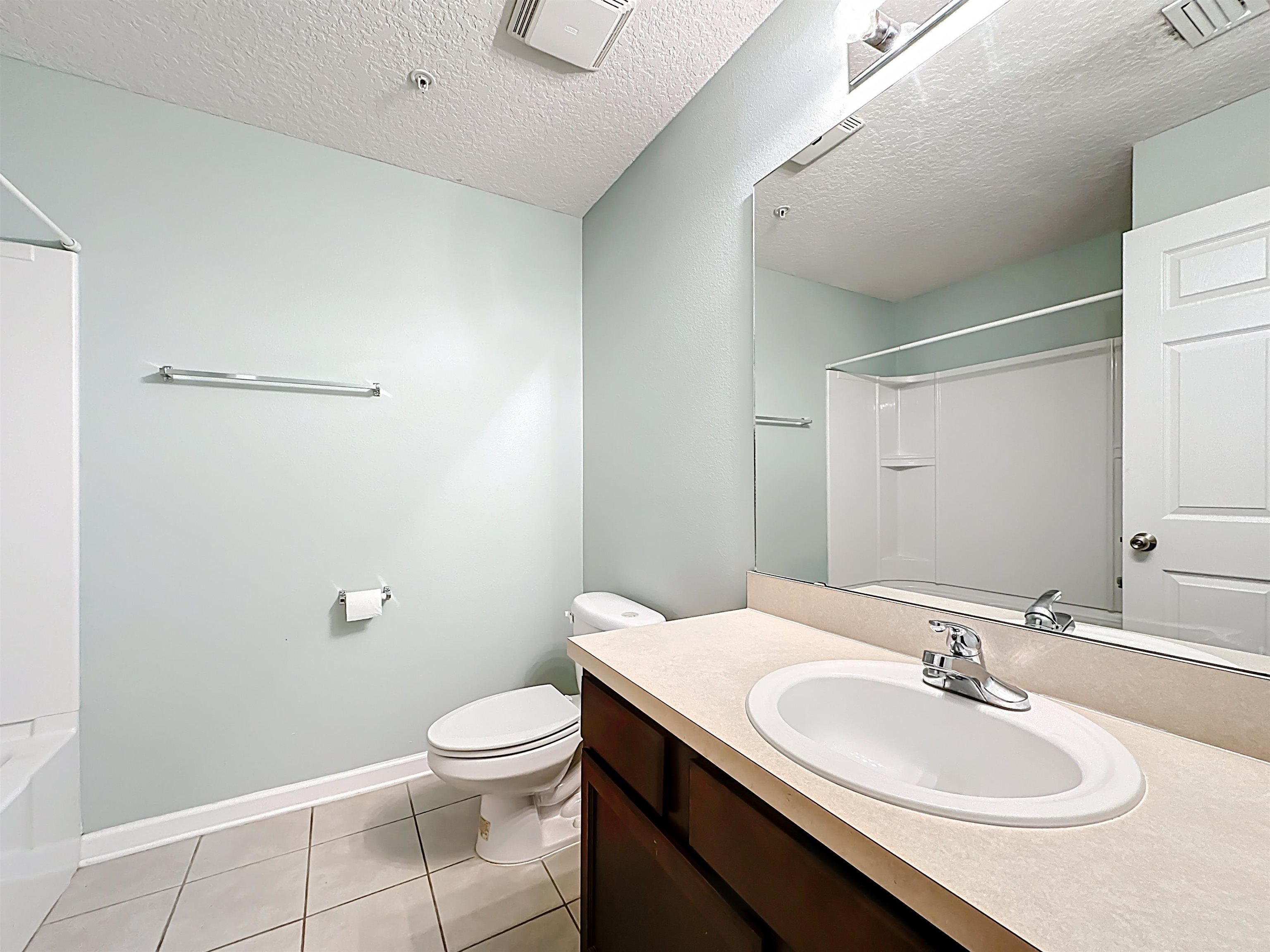 240 Golden Lake Loop St. Augustine, FL 32084 - Photo 23 of 31 Full bath featuring washtub / shower combination, vanity, light tile patterned floors, and a textured ceiling