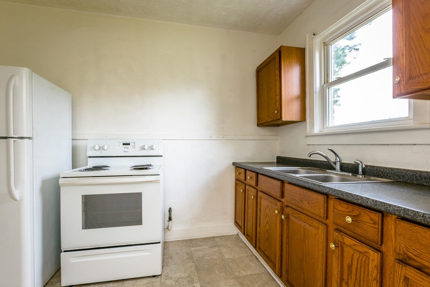 613 Alpha Street Waynesboro, VA 22980 - Photo 9 of 16 a kitchen with granite countertop a sink stove and refrigerator