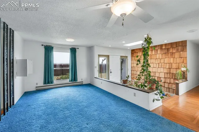 a view of a livingroom with furniture and staircase