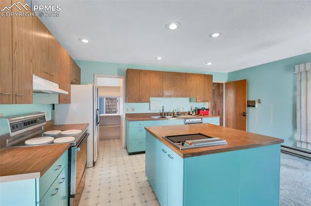 a kitchen with a sink cabinets and wooden floor