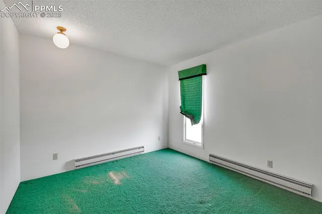 a view of an empty room with closet