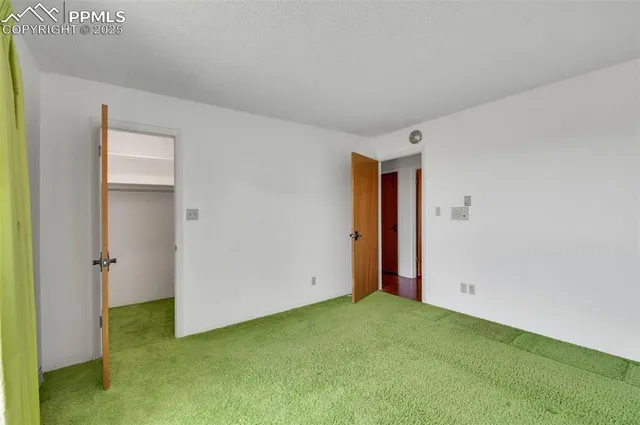 a view of a house with wooden fence