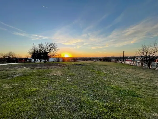 a view of a field with an ocean