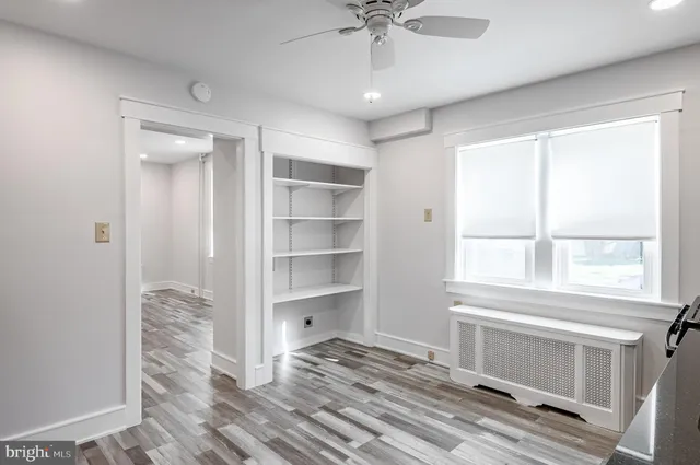 a view of bedroom with window and cabinet