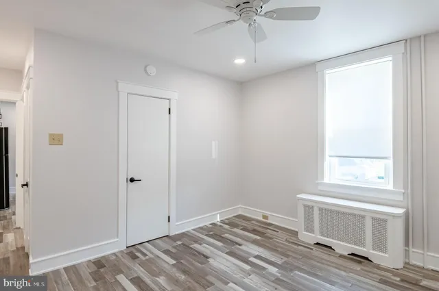 a view of a livingroom with a window and wooden floor