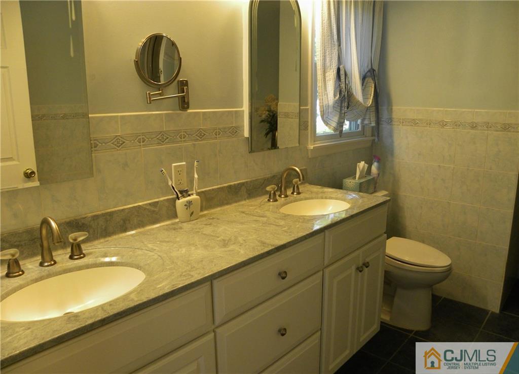 13 Russett Road Somerset, NJ 08873 - Photo 11 of 20 a bathroom with a sink and a mirror