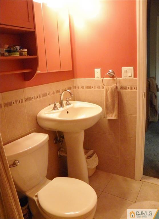 13 Russett Road Somerset, NJ 08873 - Photo 18 of 20 a white toilet sitting next to a bathroom sink
