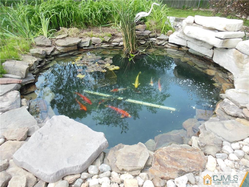 13 Russett Road Somerset, NJ 08873 - Photo 3 of 20 a view of a lake with a yard