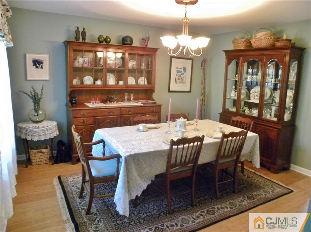13 Russett Road Somerset, NJ 08873 - Photo 5 of 20 a dining room with furniture a rug and a chandelier