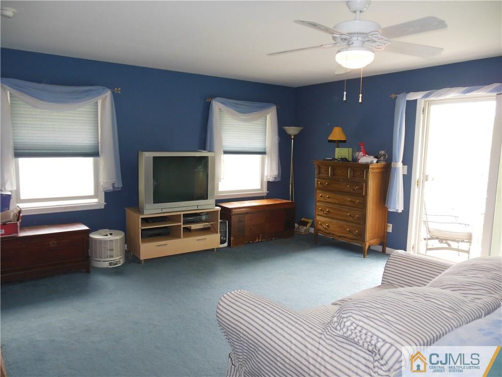 13 Russett Road Somerset, NJ 08873 - Photo 9 of 20 a living room with furniture and a flat screen tv