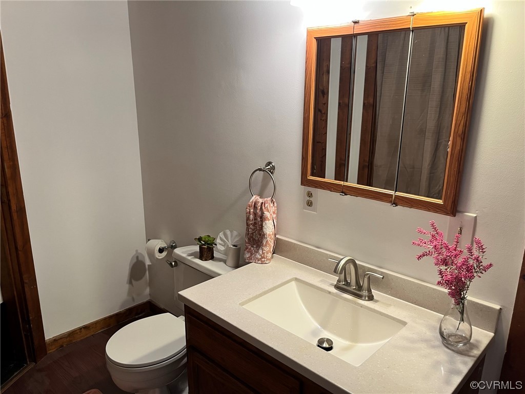 2813 Shiloh Church Road Midlothian, VA 23112 - Photo 8 of 11 a bathroom with a sink a toilet and mirror