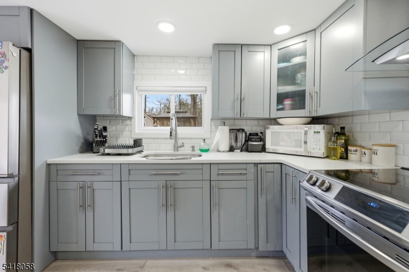 28 Wagners Lane Warren, NJ 07059 - Photo 22 of 50 a kitchen with cabinets appliances a sink and a counter top space