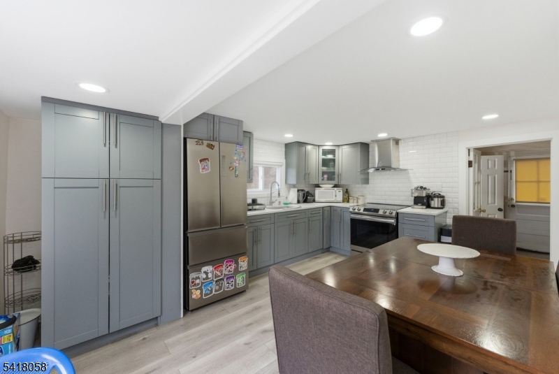 28 Wagners Lane Warren, NJ 07059 - Photo 25 of 50 a kitchen with stainless steel appliances granite countertop a sink refrigerator and cabinets