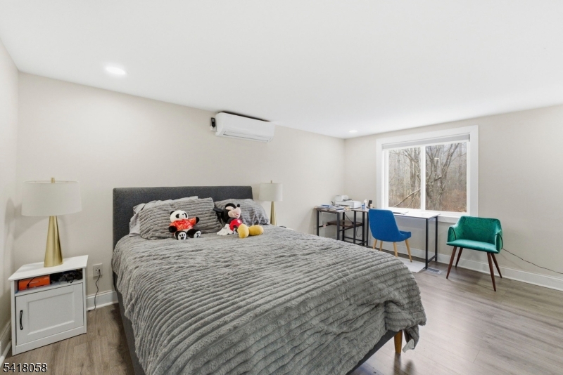 28 Wagners Lane Warren, NJ 07059 - Photo 29 of 50 a bedroom with a bed and a chair