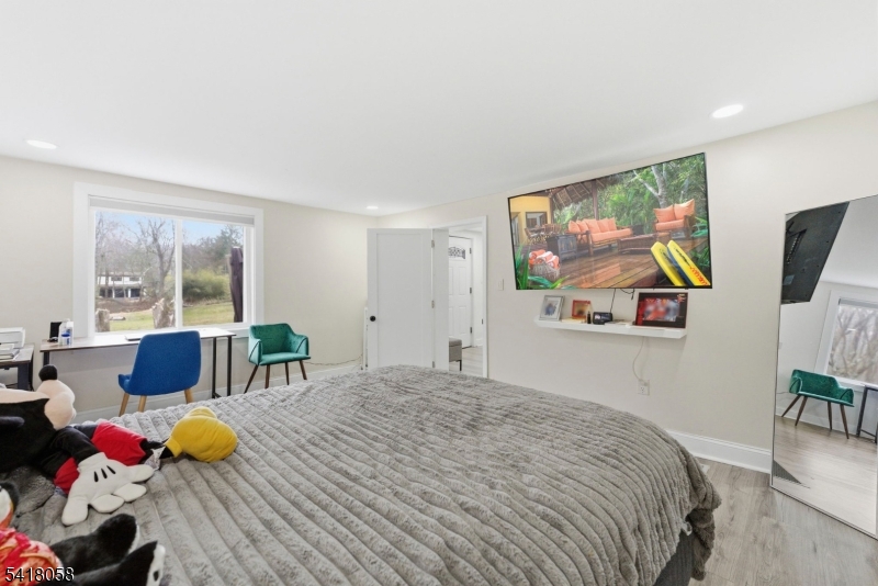 28 Wagners Lane Warren, NJ 07059 - Photo 30 of 50 a bedroom with furniture and a flat screen tv